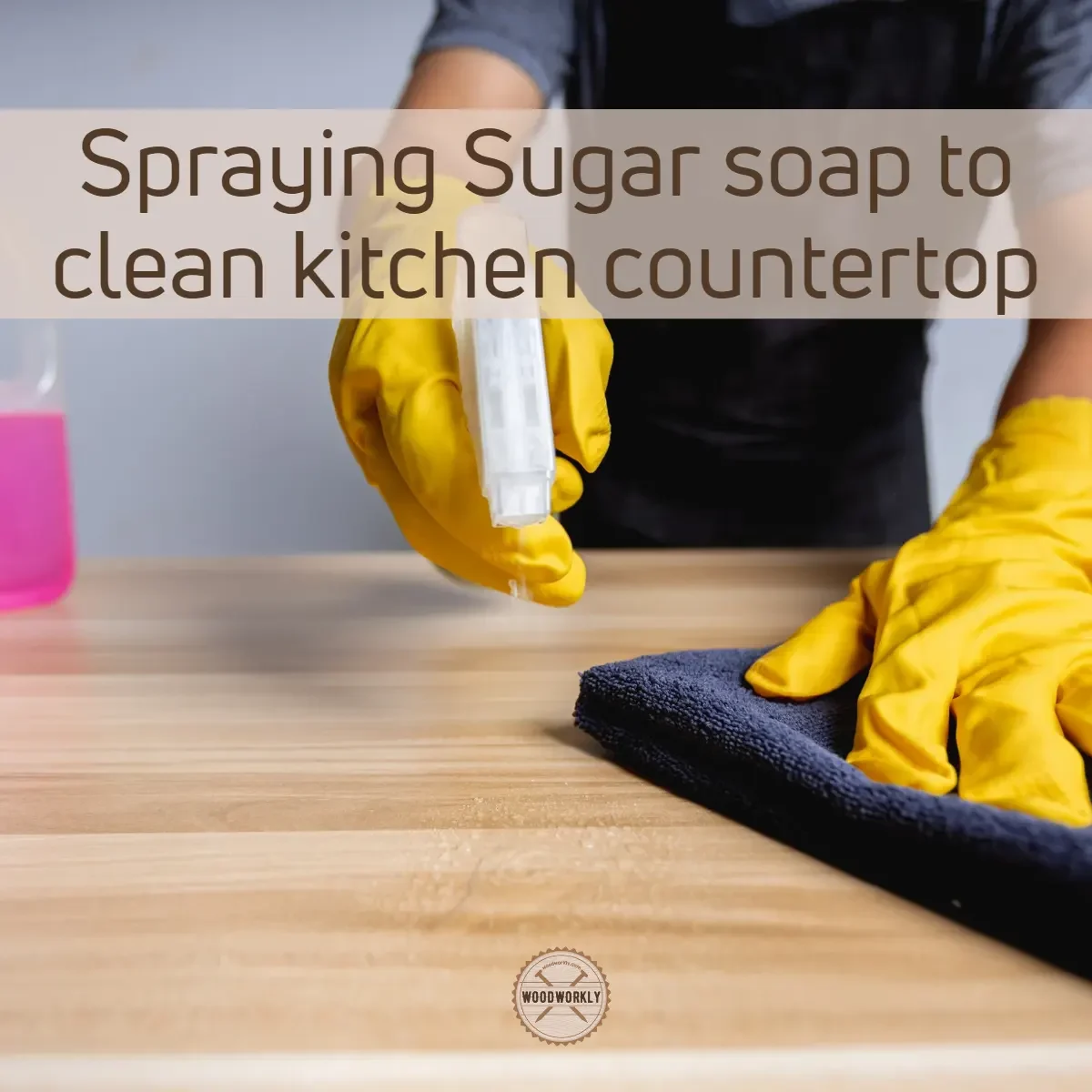 Spraying Sugar soap to clean kitchen countertop